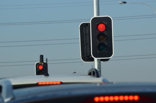 Two traffic lights with red lights