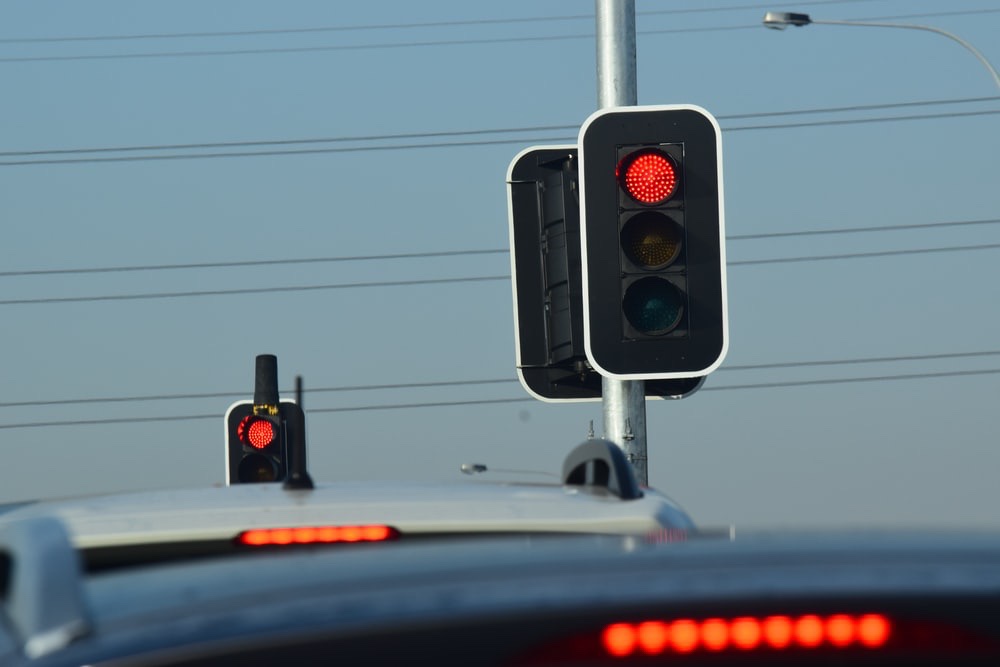 Two traffic lights with red lights